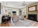 Bright living room boasts a fireplace, hardwood floors and a stylish chandelier at 574 Chicasaw Ne Dr, Marietta, GA 30060