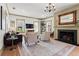 Elegant living room with a fireplace, ornate mirror, chandelier, and large windows at 574 Chicasaw Ne Dr, Marietta, GA 30060