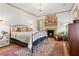 Inviting main bedroom features a fireplace, chandelier, and a large area rug at 574 Chicasaw Ne Dr, Marietta, GA 30060