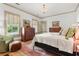 Cozy main bedroom with large windows, chandelier and hardwood floors at 574 Chicasaw Ne Dr, Marietta, GA 30060
