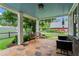 Inviting front porch with flagstone flooring, bench seating, wind chimes, and view of landscaped backyard at 574 Chicasaw Ne Dr, Marietta, GA 30060