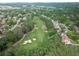 An aerial view of a golf course winding through a neighborhood at 8340 Colonial Pl, Duluth, GA 30097