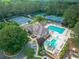 Aerial view of a community clubhouse, pool, water slides, and tennis courts at 8340 Colonial Pl, Duluth, GA 30097