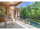 A peaceful patio with a table overlooks a sparkling pool and lush greenery at 8340 Colonial Pl, Duluth, GA 30097