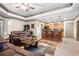 Basement area featuring a bar with seating, hardwood cabinets, a leather couch, and a coffered ceiling at 8340 Colonial Pl, Duluth, GA 30097