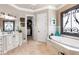Luxurious bathroom featuring a soaking tub, separate vanities, and a walk-in closet for added convenience at 8340 Colonial Pl, Duluth, GA 30097