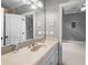 Bathroom featuring a vanity with a large mirror, neutral countertops and paint, and a view into the next room at 8340 Colonial Pl, Duluth, GA 30097
