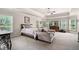 Bedroom with tray ceilings and a view of the wooded outdoors at 8340 Colonial Pl, Duluth, GA 30097