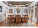 Formal dining room with decorative chandelier, a large bay window, and seating for six at 8340 Colonial Pl, Duluth, GA 30097