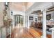 Elegant foyer with hardwood floors, decorative columns, and views into the dining and living areas at 8340 Colonial Pl, Duluth, GA 30097