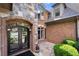 Close-up of the front entrance featuring a beautiful iron door, brick and stone architecture at 8340 Colonial Pl, Duluth, GA 30097