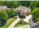 A stately home with manicured landscaping and a circular driveway at 8340 Colonial Pl, Duluth, GA 30097