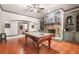 Game room with hardwood flooring, a pool table, a stone fireplace, and built in shelving at 8340 Colonial Pl, Duluth, GA 30097