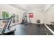 Home gym with workout equipment, mirrors, rubber flooring and doors to the outside at 8340 Colonial Pl, Duluth, GA 30097