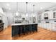 Gourmet kitchen featuring a large island with seating and stainless-steel appliances at 8340 Colonial Pl, Duluth, GA 30097