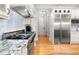 Chef's kitchen with a professional-grade stove, granite countertops, and custom cabinets at 8340 Colonial Pl, Duluth, GA 30097