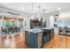 Modern kitchen featuring a large island, stainless steel appliances, and a breakfast area with ample natural light at 8340 Colonial Pl, Duluth, GA 30097