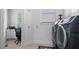 Functional laundry room with modern appliances, a built-in desk, and ample storage space for convenience at 8340 Colonial Pl, Duluth, GA 30097