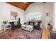 Comfortable living room featuring vaulted ceilings, a fireplace, and a cozy seating area with natural light at 8340 Colonial Pl, Duluth, GA 30097