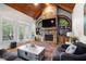 Inviting living room with a stone fireplace, vaulted ceiling, and French doors leading to an outdoor area at 8340 Colonial Pl, Duluth, GA 30097
