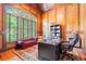 Wood paneled office with a large window, built-in bookshelves and an executive desk at 8340 Colonial Pl, Duluth, GA 30097