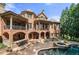 A large brick home featuring multiple balconies and a stunning pool with spa at 8340 Colonial Pl, Duluth, GA 30097
