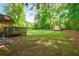 Spacious backyard featuring a small wooden deck and mature trees offering shade at 2054 Fargo Se Pl, Atlanta, GA 30316