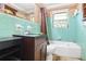 Retro bathroom featuring turquoise tiling, dark vanity, and a tub with shower at 2054 Fargo Se Pl, Atlanta, GA 30316