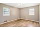 Bedroom featuring hardwood floors, two windows, and neutral colored walls at 2054 Fargo Se Pl, Atlanta, GA 30316