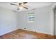 Bedroom with hardwood floors, bare walls, and a window offering outdoor views at 2054 Fargo Se Pl, Atlanta, GA 30316