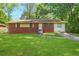 Charming single-story brick home with a well-maintained lawn and mature trees on a sunny day at 2054 Fargo Se Pl, Atlanta, GA 30316