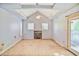 Living room with vaulted ceiling, wood burning fireplace, and exterior door at 2054 Fargo Se Pl, Atlanta, GA 30316