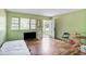 Living room with wood floor, a window, and an open door to the home's exterior at 2054 Fargo Se Pl, Atlanta, GA 30316