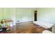 Spacious living room with wood floors, light green walls, and light streaming through an exterior window at 2054 Fargo Se Pl, Atlanta, GA 30316