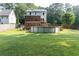 Spacious backyard featuring a pool, two-story deck, and lush green grass at 3112 Calumet Nw Cir, Kennesaw, GA 30152