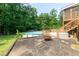 Enjoy the backyard with a pool, hot tub, and fire pit surrounded by lush greenery at 3112 Calumet Nw Cir, Kennesaw, GA 30152