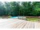 Relax on the spacious wooden deck overlooking the above-ground pool and lush greenery at 3112 Calumet Nw Cir, Kennesaw, GA 30152