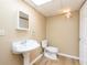 Basement bathroom features a pedestal sink, tile floors and lighting fixtures at 3112 Calumet Nw Cir, Kennesaw, GA 30152