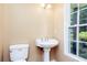 Small bathroom featuring a pedestal sink, toilet, and modern lighting at 3112 Calumet Nw Cir, Kennesaw, GA 30152