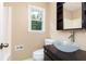 Stylish bathroom with vessel sink, dark vanity, and modern fixtures at 3112 Calumet Nw Cir, Kennesaw, GA 30152