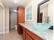 Bathroom featuring granite countertops, a modern glass bowl sink, a large mirror, and ample storage at 3112 Calumet Nw Cir, Kennesaw, GA 30152