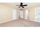 This bedroom features plush carpet and a ceiling fan and access to the outside via a door at 3112 Calumet Nw Cir, Kennesaw, GA 30152