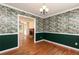 Open dining room with traditional wallpaper leads to living area with fireplace at 3112 Calumet Nw Cir, Kennesaw, GA 30152