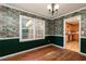 Charming dining room features hardwood floors, chair rail, and unique wallpaper at 3112 Calumet Nw Cir, Kennesaw, GA 30152
