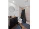Contemporary bathroom featuring a stone tiled shower with dark fixtures and modern vanity at 405 Branch Forest Way, Stockbridge, GA 30281