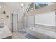 Bright bathroom with a soaking tub, large windows, and modern fixtures at 405 Branch Forest Way, Stockbridge, GA 30281