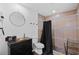 Cozy bathroom featuring a shower with a rainfall showerhead and dark fixtures at 405 Branch Forest Way, Stockbridge, GA 30281