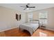 Bright bedroom with hardwood floors, ceiling fan, and natural light at 405 Branch Forest Way, Stockbridge, GA 30281