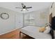 Bright bedroom featuring hardwood floors, a ceiling fan, and neutral decor at 405 Branch Forest Way, Stockbridge, GA 30281