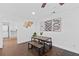 Bright dining area with a wooden table, bench seating, and contemporary artwork on the white walls at 405 Branch Forest Way, Stockbridge, GA 30281